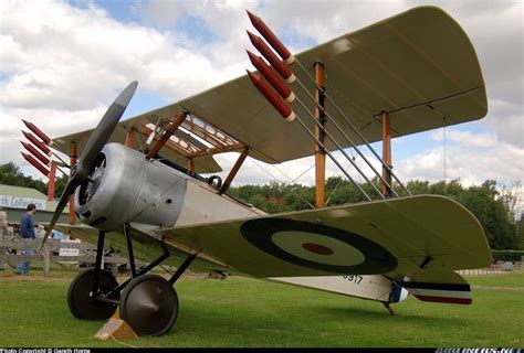 an old airplane is parked on the grass