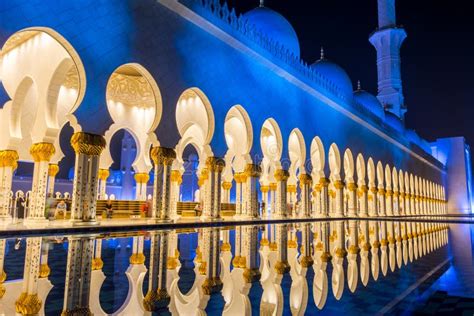 Night View of Poles of Grand Mosque in Abu Dhabi, UAE and Reflection in ...