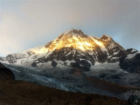 Sunrise on Annapurna South. Part of the Annapurna massif which has the ...