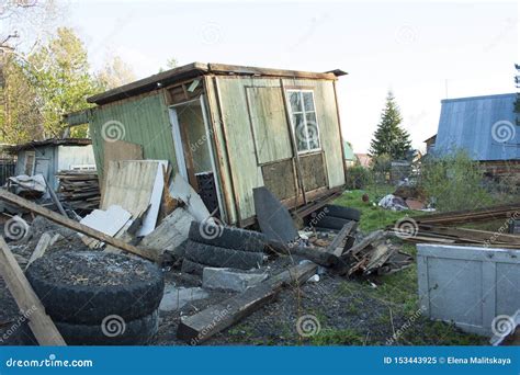 Completely Ruined Wooden House. Around Different Trash, Tires, Boards ...