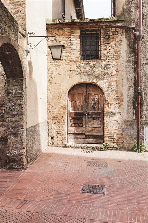 an old brick building with a wooden door and arched doorway in the ...