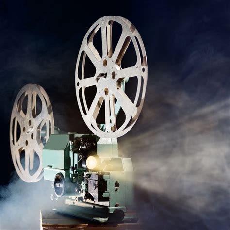 Old retro movie projector with smoke and light beam