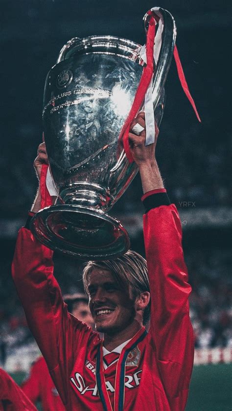 a man holding up a silver trophy on top of his head in front of a crowd