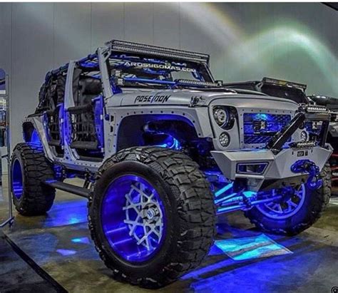 THIS SILVER JEEP JK IS DECKED OUT IN BLUE LIGHTS AND BLUE RIMS NOT TO ...