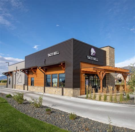 the outside of a restaurant with an awning and wood trimmings on it