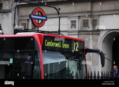 Red London Bendy Bus with Underground logo in background Stock Photo ...