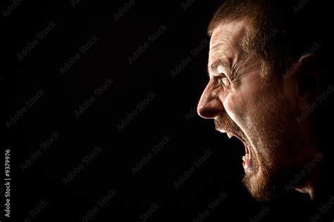 Face of angry man screaming isolated on black Stock Photo | Adobe Stock