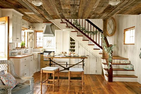 The adorably cozy kitchen, with its simple white cabinetry and walls ...