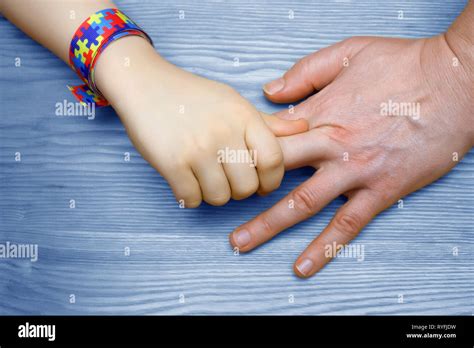 Autism Awareness Picture. Father holding hand her Autistic Child Stock ...