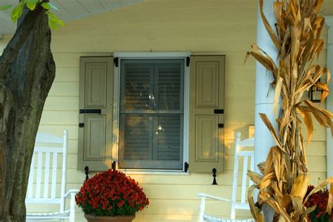 Selecting the Perfect Shutter Color | Yellow house exterior, Yellow ...