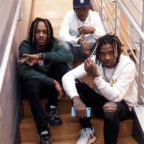 three young men sitting down on the stairs