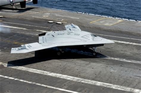 A U.S. Navy X-47B Unmanned Combat Air System makes an arrested landing ...