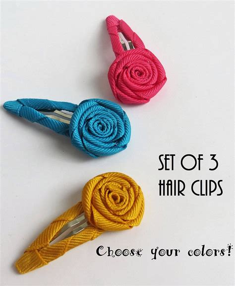 A set of 3 hair clips with handmade ribbon flowers. Each flower is ...