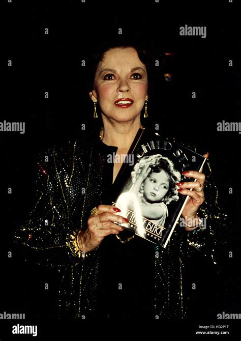 Shirley Temple holding a copy of her autobiography Stock Photo - Alamy