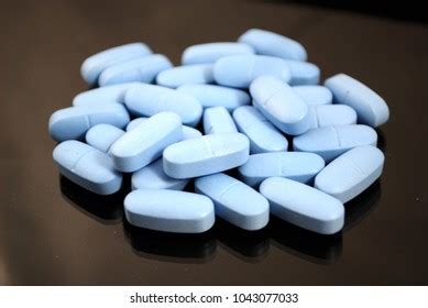 Oval Blue Tablets On Black Background Stock Photo 1043077033 | Shutterstock