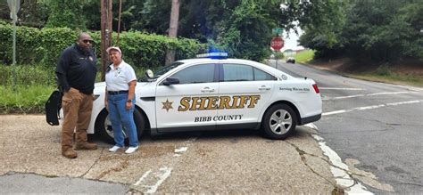 Bibb County Sheriff's Office Lt. Reginald Thomas and Judy Gordon lend a ...