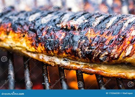 Grilled Fish with Smoke on a Charcoal Barbecue. Close Up Fish on the ...