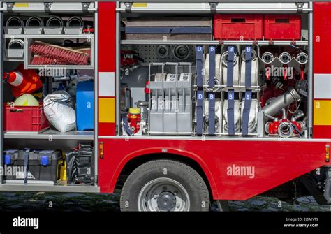 The side view of equipment inside of a fire engine. Fire truck with ...