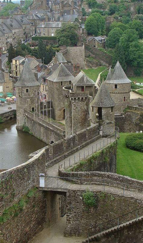 an aerial view of a castle with water in the foreground and buildings ...