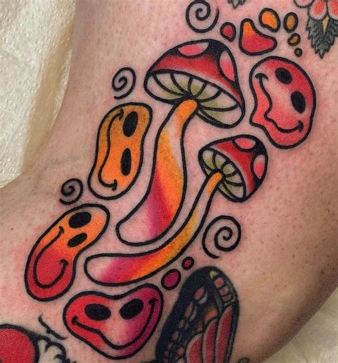 a close up of a person's leg with tattoos on it and mushrooms in the ...