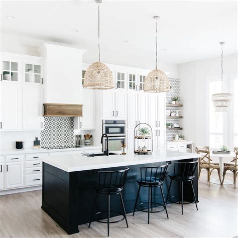 black shiplap island and white cabinets with touches of natural wood ...