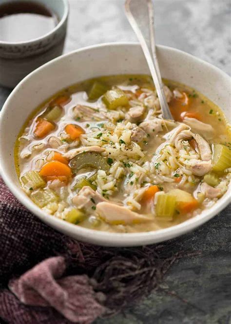 Easy chicken and rice soup in a rustic beige bowl, ready to be eaten ...