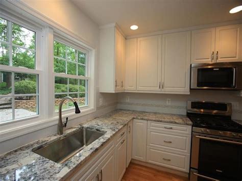 White Ice Granite With White Cabinet Backsplash Ideas.