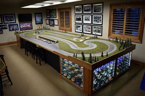 a model race track in a room with pictures on the wall