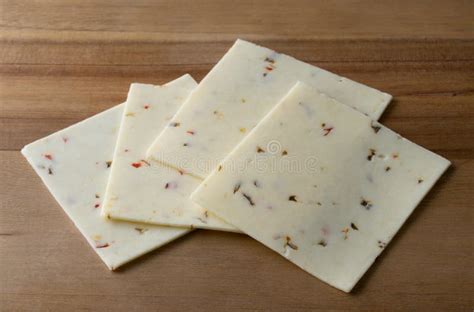 Pepperjack Cheese Slices on a Cutting Board Stock Image - Image of ...