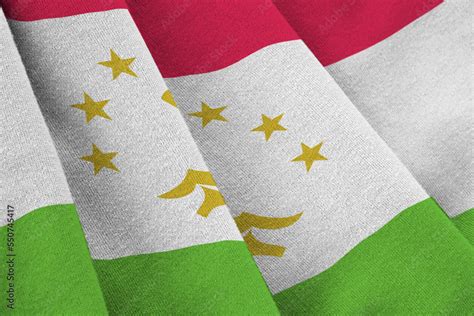 Tajikistan flag with big folds waving close up under the studio light ...