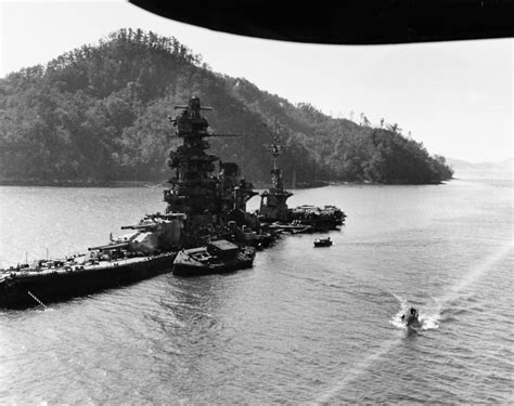 The Japanese battleship Hyuga lies in shallow water of the Kure naval ...