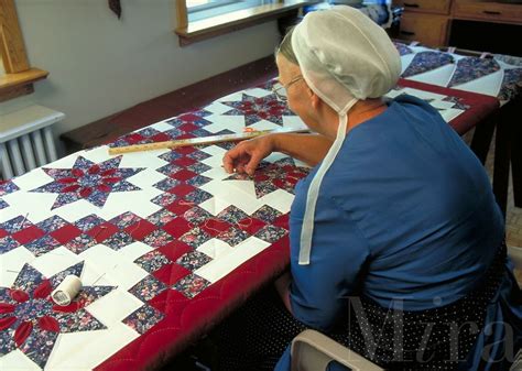 Amish Woman Quilting a New Quilt