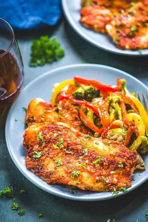 Spicy Baked Basa in a plate served along with sautéed vegetables. Oven ...