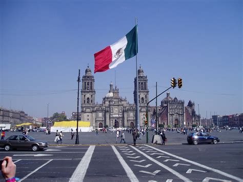 Download Mexico Flag On City Streets Wallpaper | Wallpapers.com