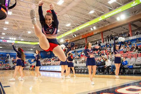 IMG_6099-17 | a cheerleader does a herkie jump during a time… | Flickr