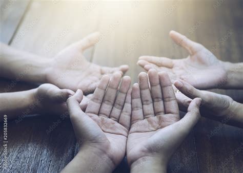 Christian bother and sister raise hands up and praying together around ...