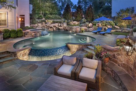 Infinity edge pool with boulder waterfall and spa. | Backyard pool ...