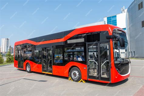 Premium Photo | Red modern city bus at the bus station on a clear day