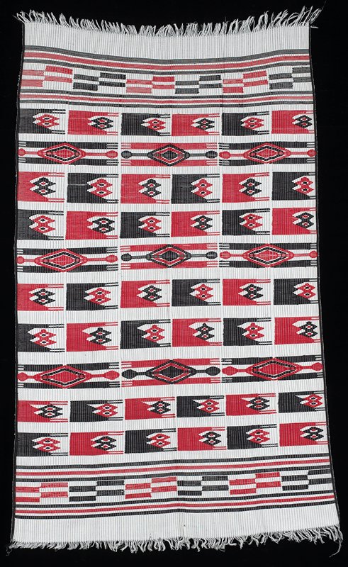 white background with thin black lines; red and black weft patterning figures; horizontal stripes at each end, alternating broken lines