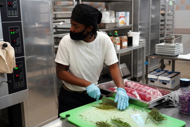 Sgt. Tashauna Walls, Field Feeding Platoon, 35th Combat Sustainment Support Battalion, 10th Support Group, prepare herb encrusted ribeye during the Japan-wide Joint Culinary Competition, held Oct. 20-21, Camp Foster, Okinawa, Japan. Walls is part...