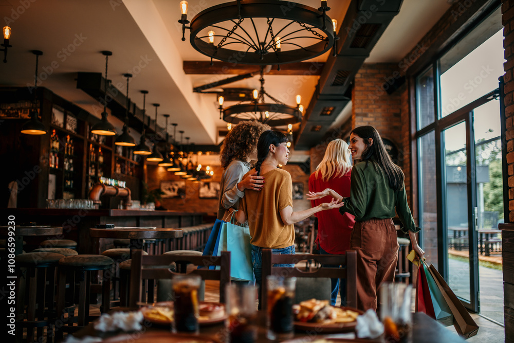 A group of smiling multiracial female friends leave the restaurant after a meal and drinks.