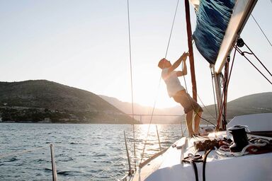 man working on sailboat