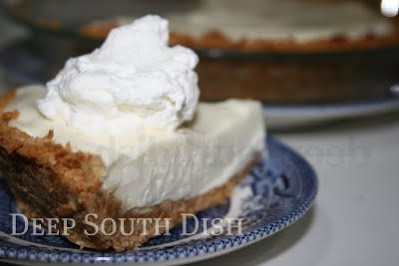 A Key lime pie made with cream cheese, sweetened condensed milk and Key lime juice in a coconut graham cracker crust and served with minty whipped cream.