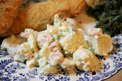 A potato salad, made with leftovers from a seafood boil, using highly seasoned red-skinned potatoes, shrimp, crawfish and crab. Shown here with fried catfish and collards If you didn't have a boil, no worries - you can still make it!