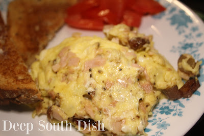 A hash of fried potatoes with chopped turkey breast, stirred with eggs.