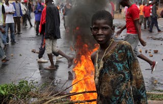 A protester poses for a photograph as they barricade a road to demonstrate against plans by Burundian President Pierre Nkurunziz