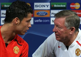 Manchester United manager Sir Alex Ferguson, right, listens to player Cristiano Ronaldo during a press conference Tuesday, Sept. 18 2007 at Alvalade stadium in Lisbon, Portugal. Manchester United will play Sporting in a Champions League Group F soccer match Wednesday. Other teams in the group are AS Roma and Dynamo Kiev. (AP Photo/Steven Governo)