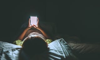 Asian woman playing game on smartphone in the bed at night,Thailand people,Addict social media