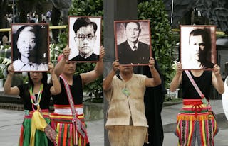 二二八 Indigenous Taiwanese hold portraits of victims of the 228 incident during the 60th anniversary at a park in Taipei