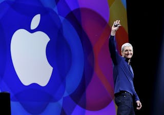 Apple CEO Tim Cook waves as he arrives on stage to deliver his keynote address at the Worldwide Developers Conference in San Fra